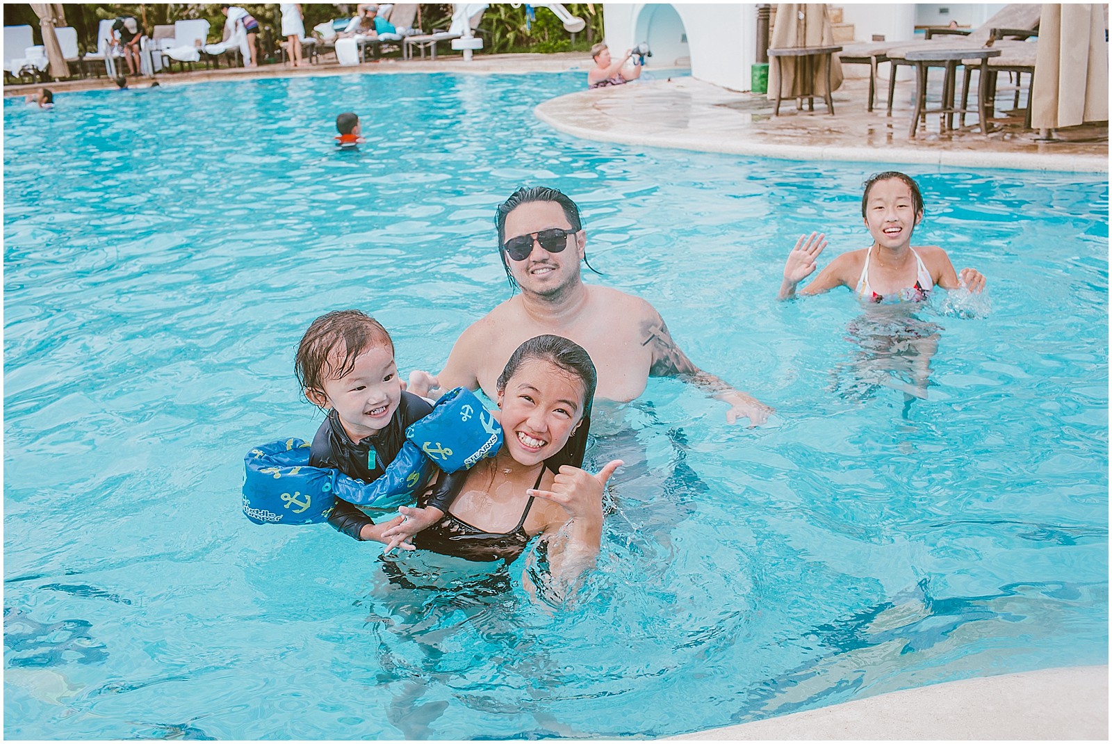 Family swimming in pool