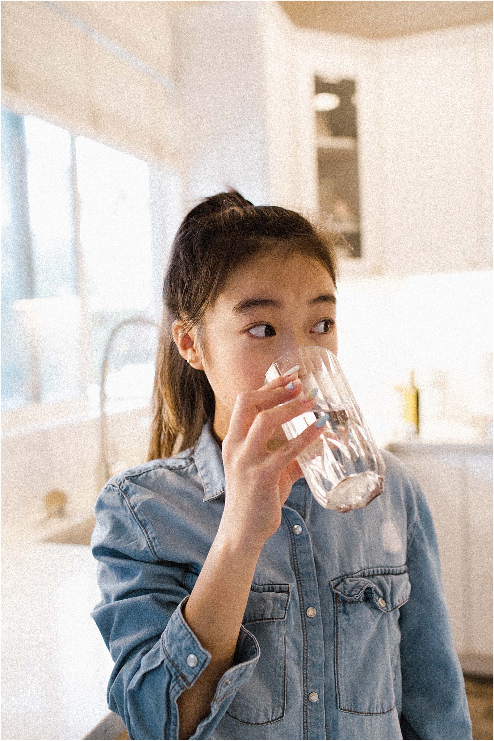 little girl drinking a glass of water