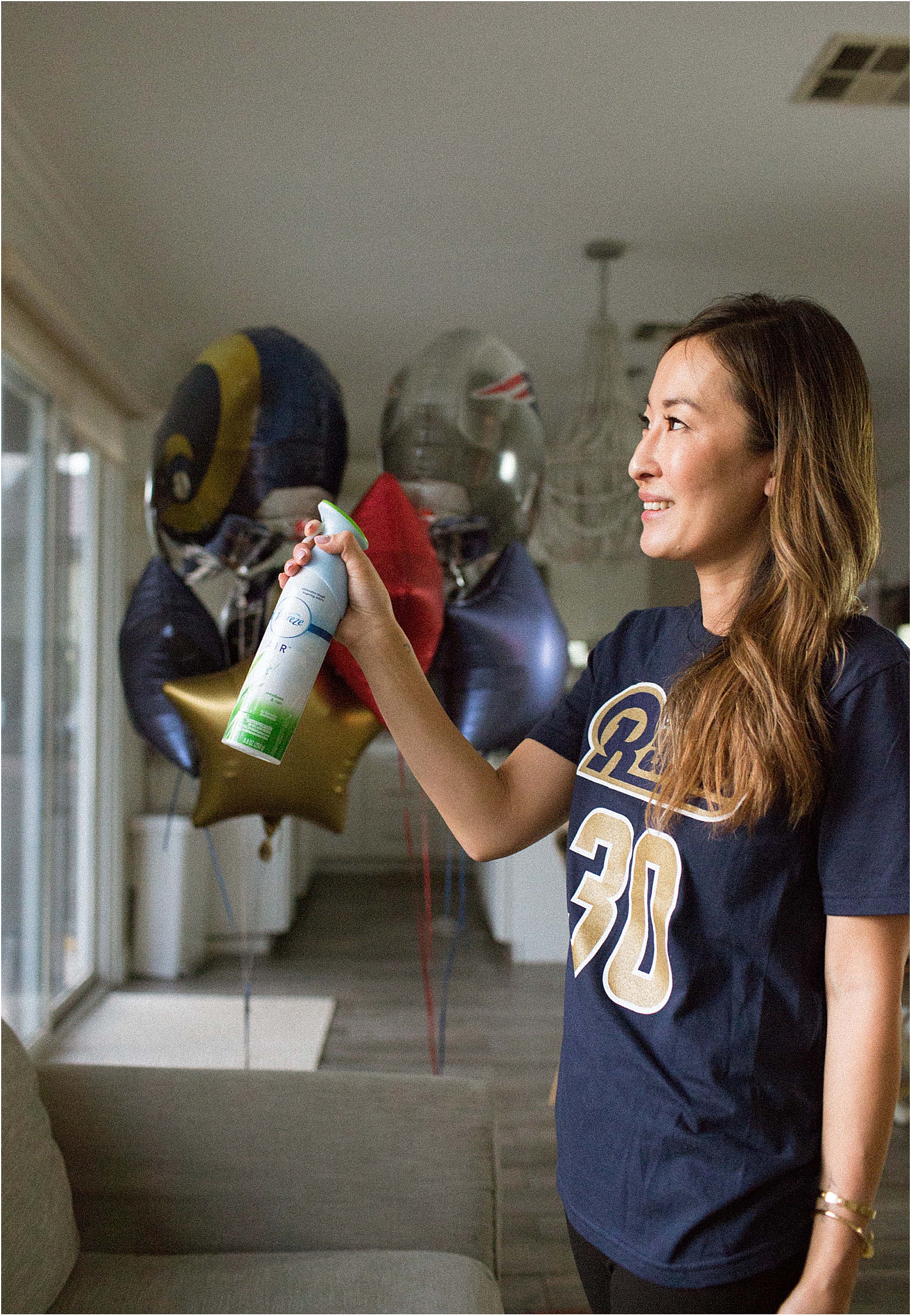 woman spraying Febreze air freshener