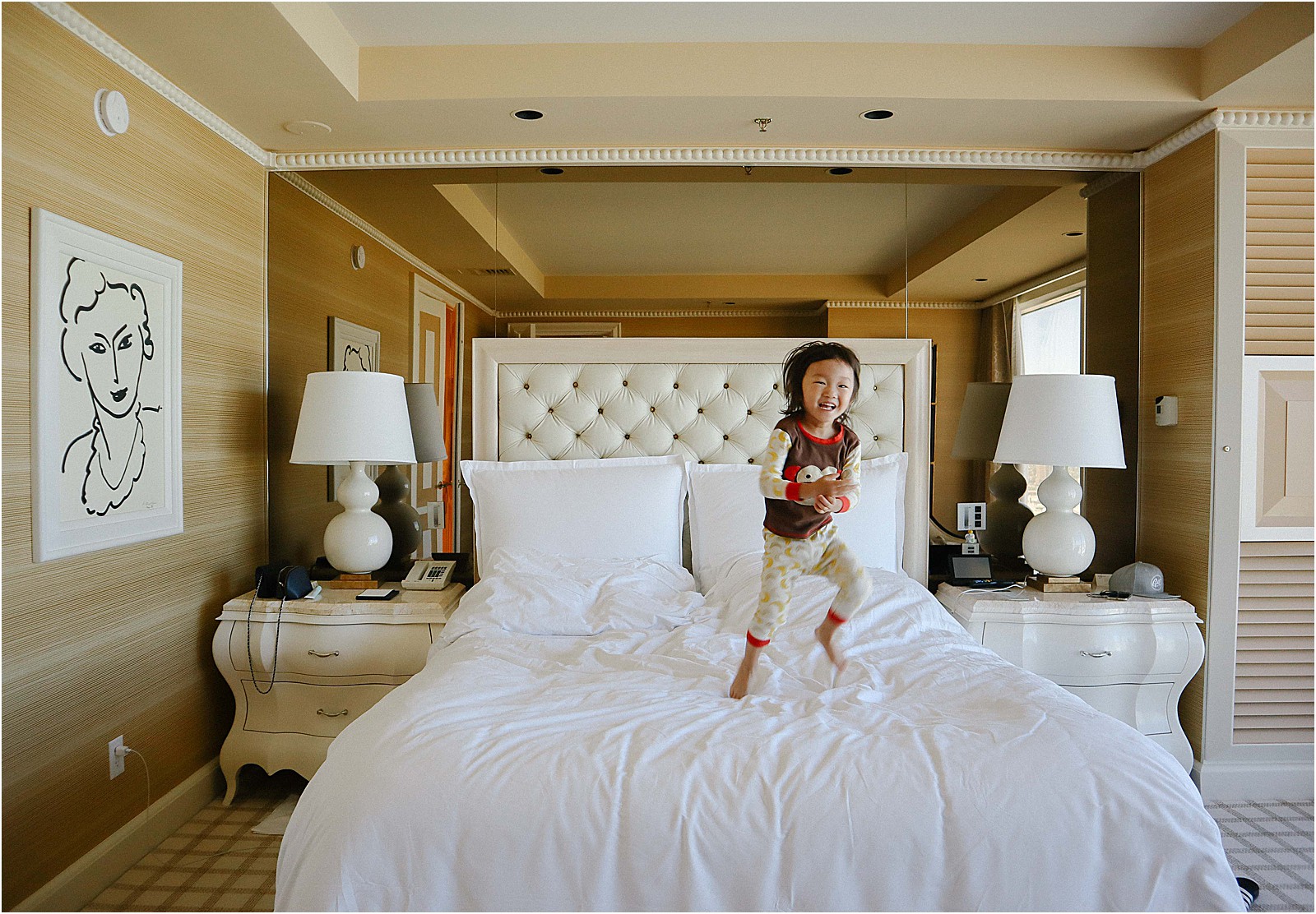 little boy jumping on bed