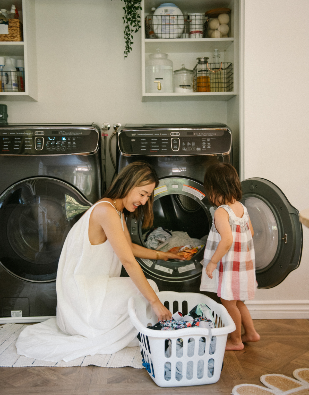 Mom and toddler doing laundry